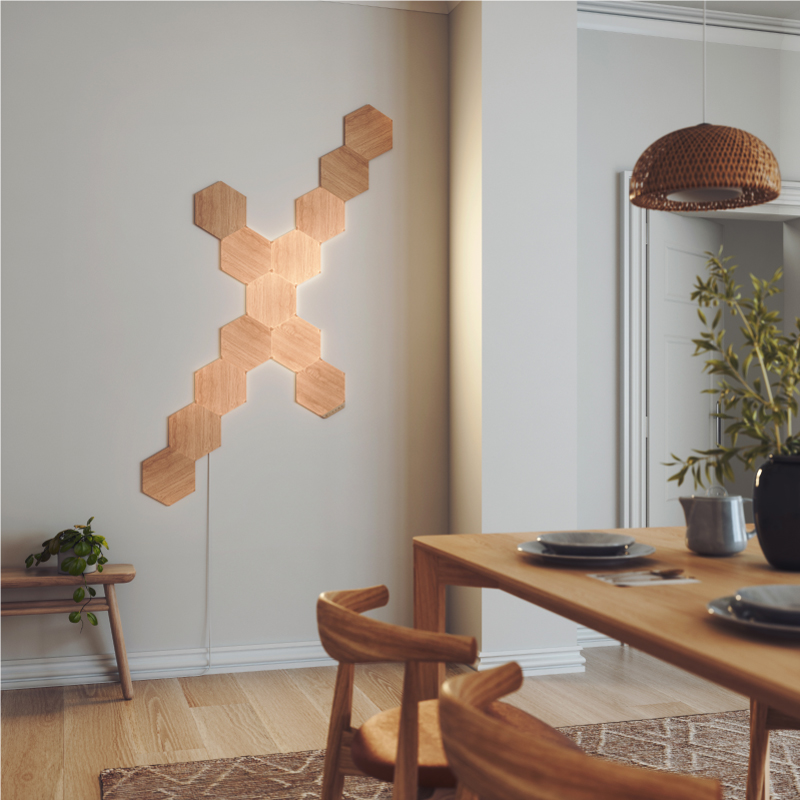 Nanoleaf Elements Thread enabled wood look hexagon smart modular light panels mounted to a wall in a dining room. Nanoleaf App. HomeKit, Google Assistant, Amazon Alexa, IFTTT.