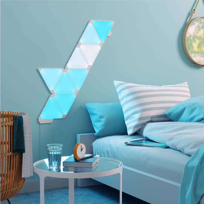 Nanoleaf Light Panels color changing triangle smart modular light panels mounted to a wall in a bedroom. Similar to Philips Hue, Lifx. HomeKit, Google Assistant, Amazon Alexa, IFTTT.