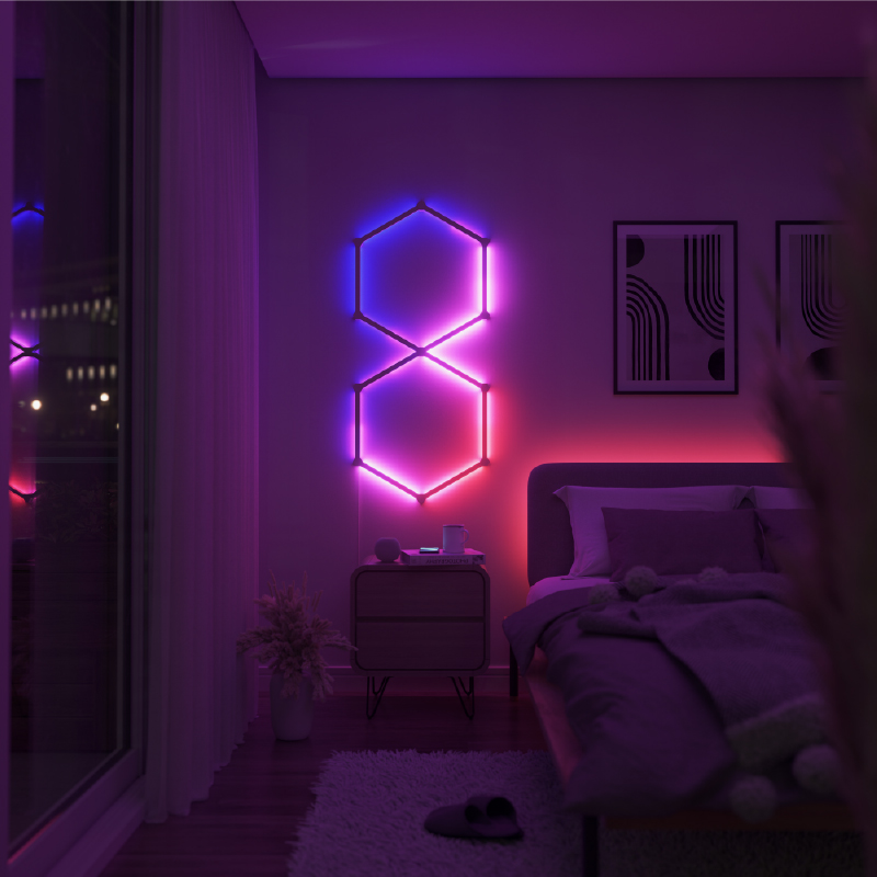 Nanoleaf Lines Thread-enabled color-changing smart modular backlit light lines mounted to a wall in a bedroom. HomeKit, Google Assistant, Amazon Alexa, IFTTT.