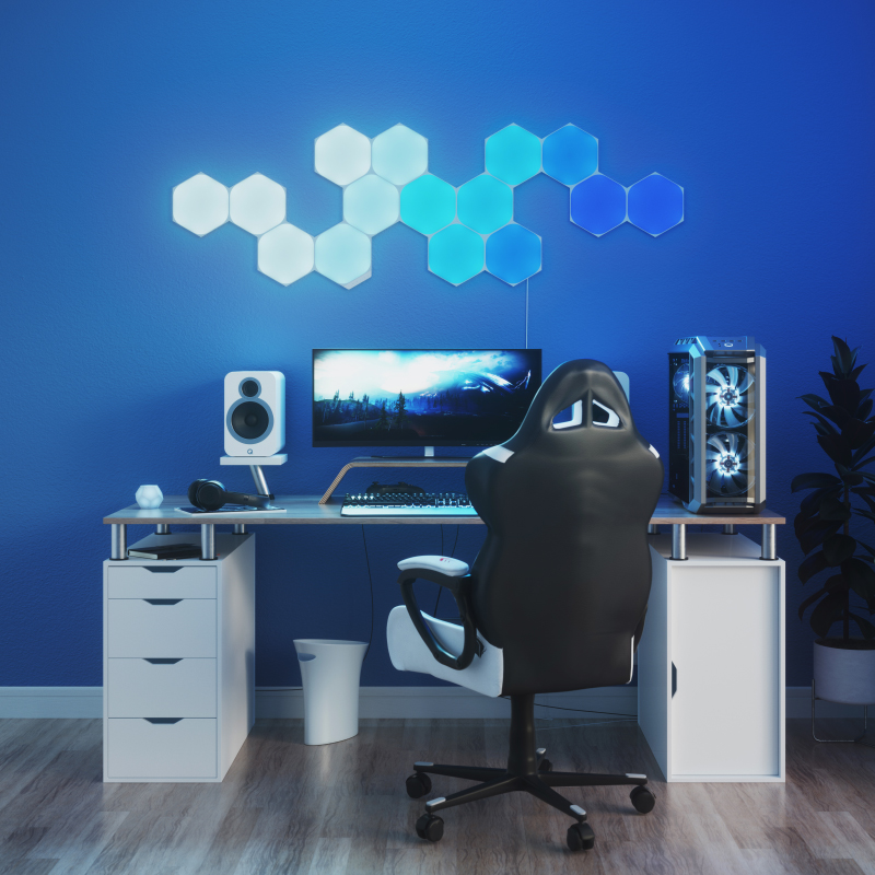 Nanoleaf Shapes Thread enabled color changing hexagon smart modular light panels mounted to a wall above a battlestation. Similar to Philips Hue, Lifx. HomeKit, Google Assistant, Amazon Alexa, IFTTT.